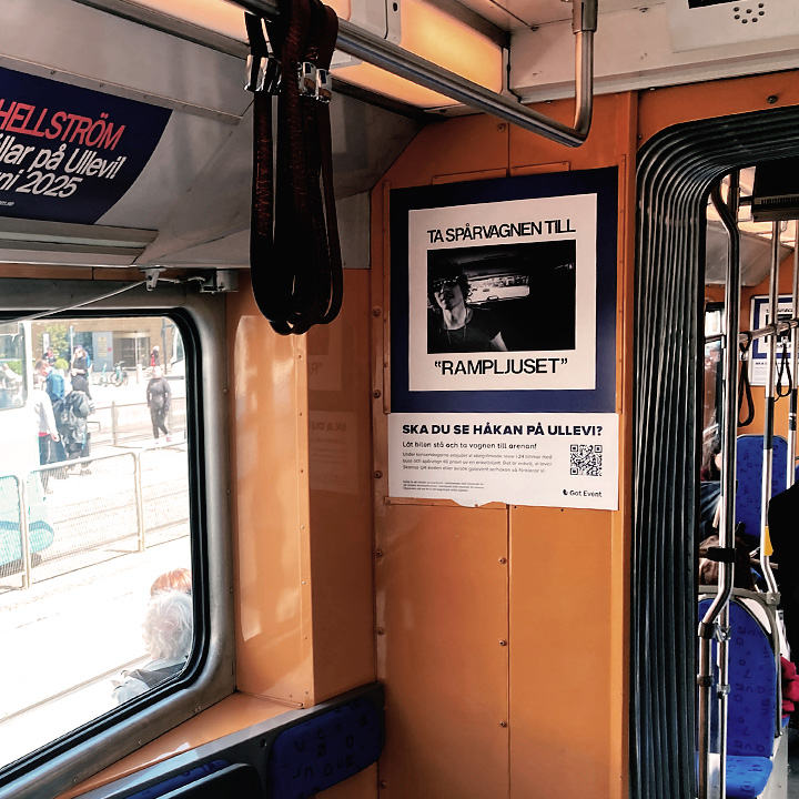 Printed advertisement hanging in tram.